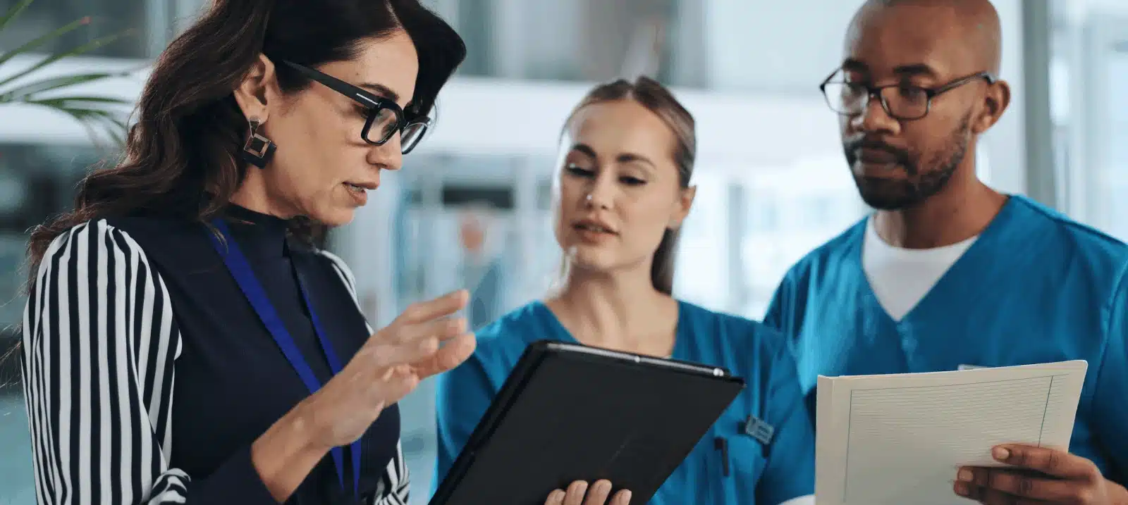 three people with tablet